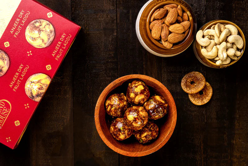 Almond House Anjeer Dryfruit Laddu with Almonds, Cashews, and Figs in a Wooden Bowl and Packaging