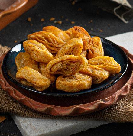 Close-up of Almond House Khara Khaja arranged in a decorative bowl